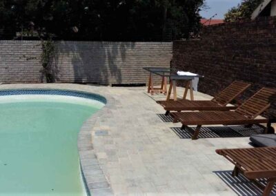 Garsfontein Residential Swimming Pool & Surroundings Paved In A Strecherbond Packing Style