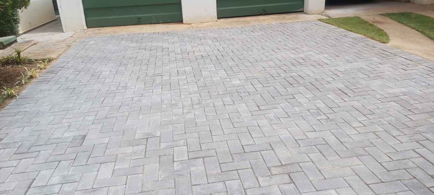 Driveway Paving Pretoria & Centurion 7 Pale grey paved driveway laid in a herringbone pattern in front of a double garage in Irene, Centurion