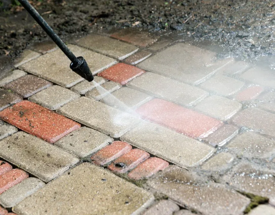 How to Clean Paving Bricks 2 A pressure washer lance clearing soiled brick paving, the washed area lighter and the coursing sharper than the dulled surface still to be cleaned